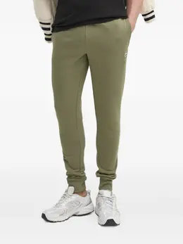 Lacoste: Зелёные брюки 